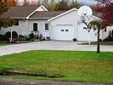 Residential concrete driveway with extra parking area suitable for turn-around purposes.